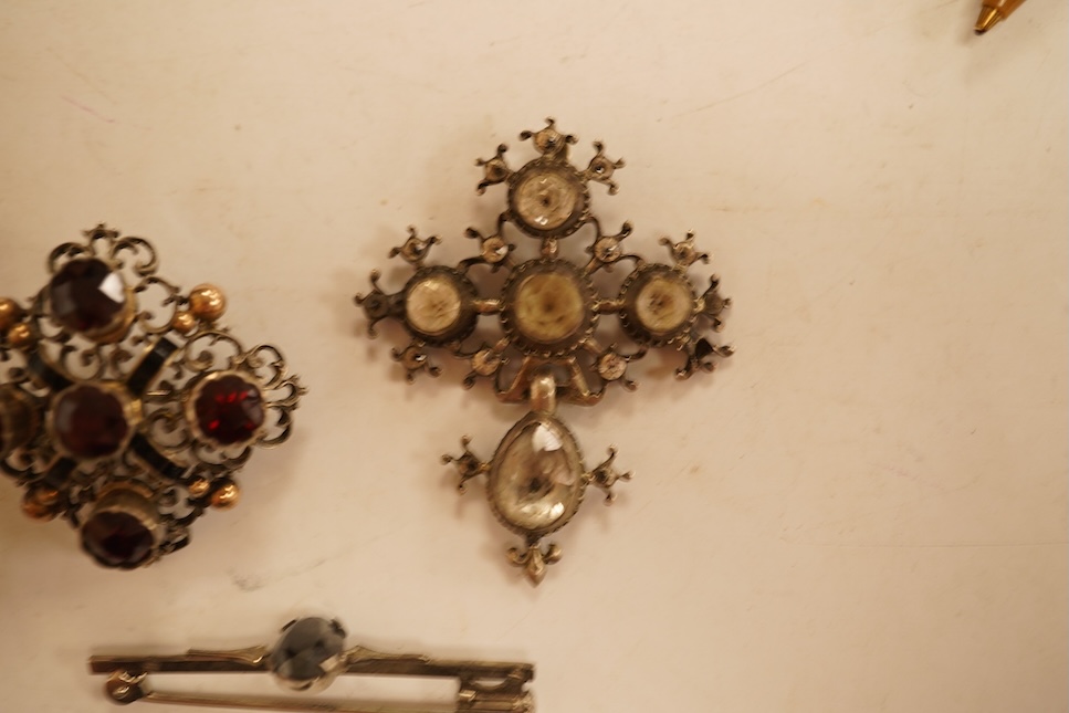 A late 19th/early 20th century Viennese pierced white metal, enamel and garnet cluster set brooch, 34mm, together with four other items of paste set jewellery.